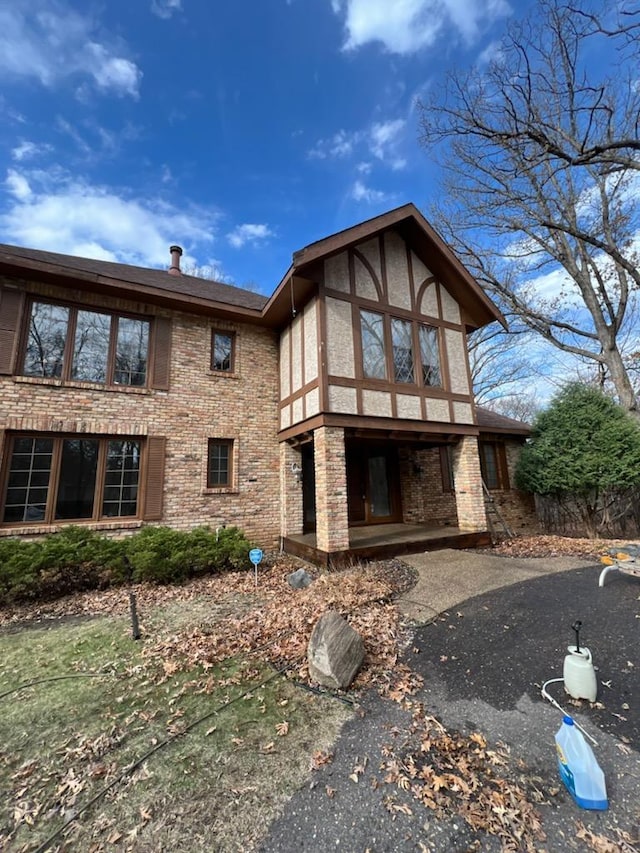 2700 Olde Wood Ct, Minnetonka, MN 55391 - back of house featuring a carport, driveway, brick siding, and stucco siding