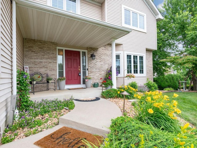 1632 Seashell Ln, Waconia, MN 55387 - doorway to property featuring covered porch and brick siding