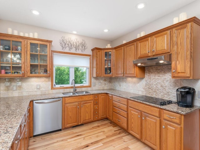 1632 Seashell Ln, Waconia, MN 55387 - kitchen with stainless steel dishwasher, under cabinet range hood, black electric cooktop, light wood finished floors, and brown cabinets