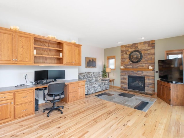 1632 Seashell Ln, Waconia, MN 55387 - office with built in study area, light wood finished floors, and a fireplace