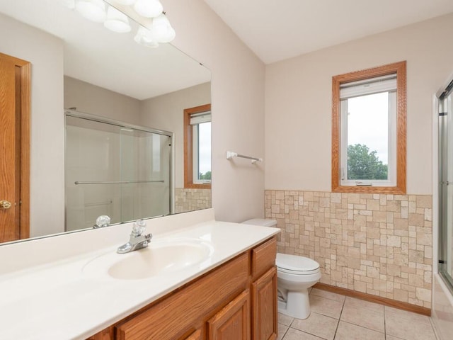 1632 Seashell Ln, Waconia, MN 55387 - bathroom with a shower with shower door, vanity, tile patterned floors, and tile walls
