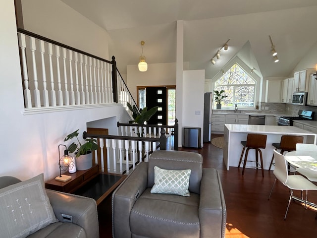 23120 Gardner Ave, Rogers, MN 55374 - living area with lofted ceiling, stairs, and dark wood-style floors
