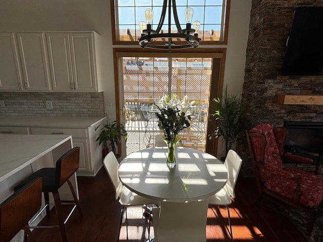 23120 Gardner Ave, Rogers, MN 55374 - dining area with a chandelier, dark wood finished floors, plenty of natural light, and a stone fireplace