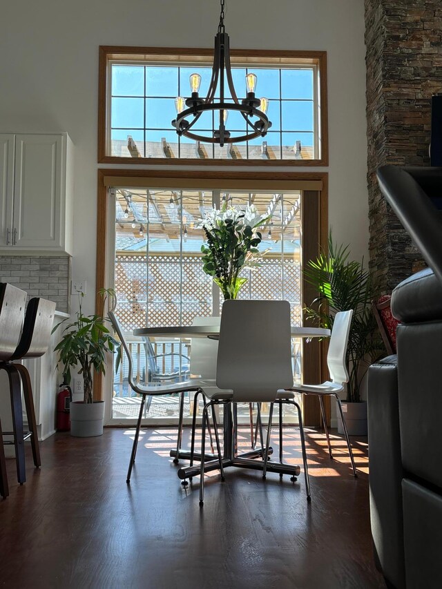 23120 Gardner Ave, Rogers, MN 55374 - dining area featuring a chandelier, dark wood-style flooring, and a high ceiling