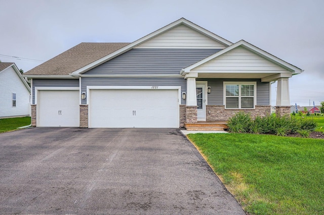 1221 136th St W, Rosemount, MN 55068 - view of front of home with driveway, a garage, a front lawn, covered porch, and stone siding