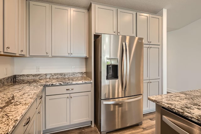 1221 136th St W, Rosemount, MN 55068 - kitchen with stainless steel fridge, wood finished floors, and light stone counters
