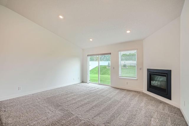 1221 136th St W, Rosemount, MN 55068 - unfurnished living room featuring carpet flooring, a glass covered fireplace, recessed lighting, and lofted ceiling