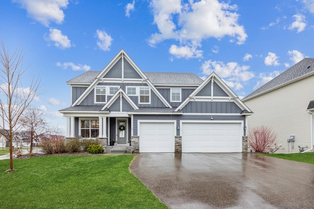 10914 23rd St NE, Saint Michael, MN 55376 - craftsman-style home with board and batten siding, driveway, stone siding, a front lawn, and an attached garage