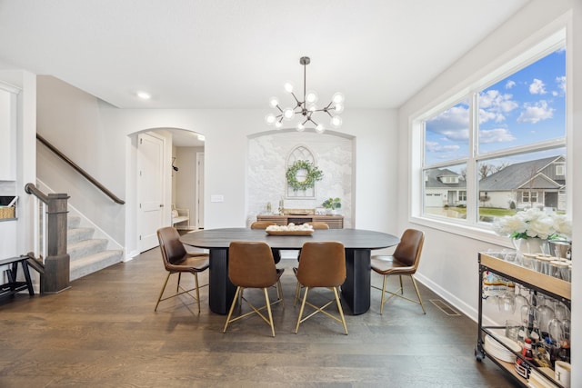 10914 23rd St NE, Saint Michael, MN 55376 - dining room with stairs, arched walkways, dark wood-style flooring, a chandelier, and recessed lighting