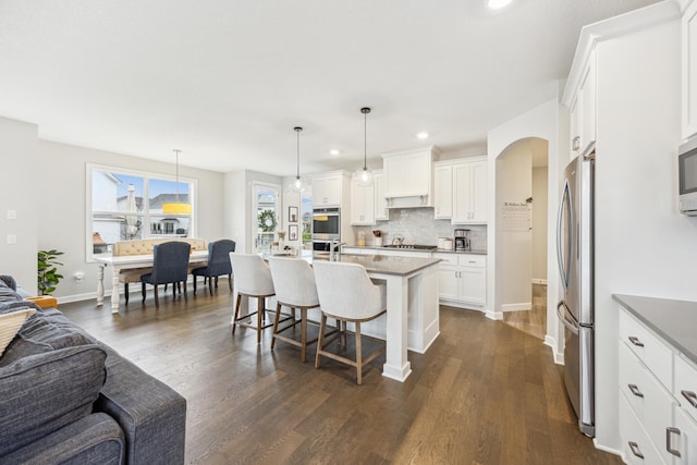10914 23rd St NE, Saint Michael, MN 55376 - kitchen featuring open floor plan, appliances with stainless steel finishes, a breakfast bar area, tasteful backsplash, and recessed lighting