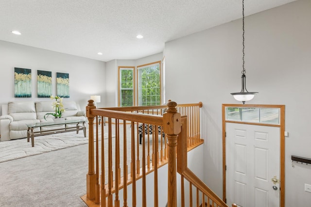 7829 Elm Grove Ln, New Hope, MN 55428 - hallway with an upstairs landing, carpet floors, recessed lighting, and a textured ceiling