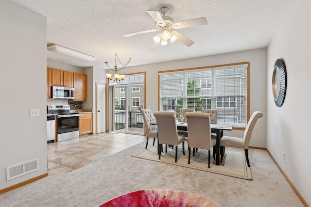 7829 Elm Grove Ln, New Hope, MN 55428 - dining room featuring a chandelier, light carpet, a textured ceiling, and a ceiling fan