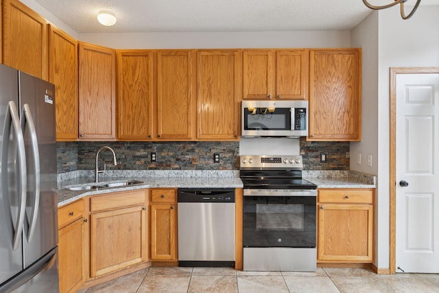 7829 Elm Grove Ln, New Hope, MN 55428 - kitchen featuring appliances with stainless steel finishes, light stone countertops, decorative backsplash, light tile patterned floors, and a textured ceiling