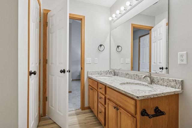 7829 Elm Grove Ln, New Hope, MN 55428 - full bathroom featuring double vanity and wood finished floors