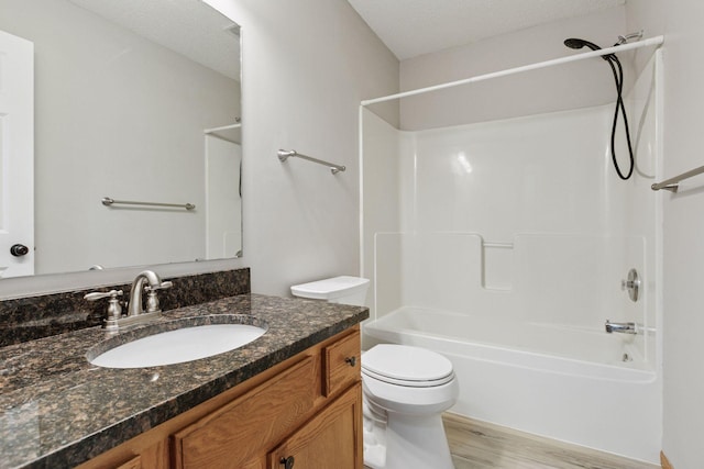 7829 Elm Grove Ln, New Hope, MN 55428 - bathroom with vanity, bathing tub / shower combination, wood finished floors, and a textured ceiling