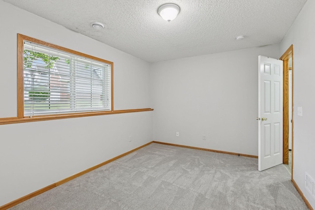 7829 Elm Grove Ln, New Hope, MN 55428 - spare room featuring a textured ceiling and light colored carpet