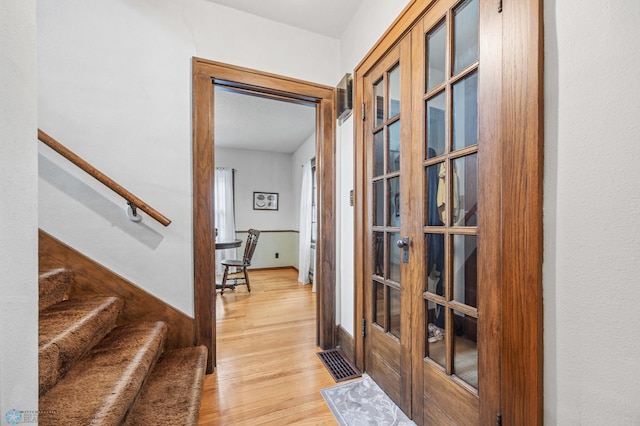 1330 12th St N, Fargo, ND 58102 - hall with french doors, light wood-style floors, and stairway