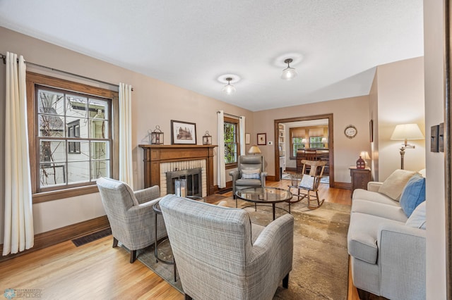 1330 12th St N, Fargo, ND 58102 - living area with light wood-style flooring and a brick fireplace