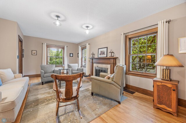 1330 12th St N, Fargo, ND 58102 - living room featuring light wood-style floors and a brick fireplace