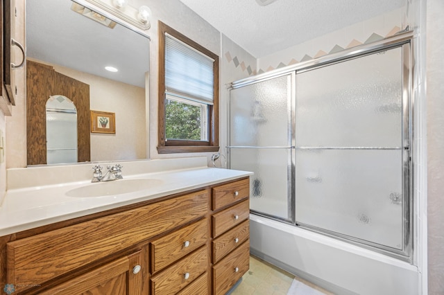 1330 12th St N, Fargo, ND 58102 - full bath with vanity, bath / shower combo with glass door, and a textured ceiling