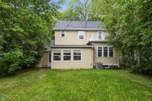 1330 12th St N, Fargo, ND 58102 - back of property with a balcony, a lawn, and a shingled roof