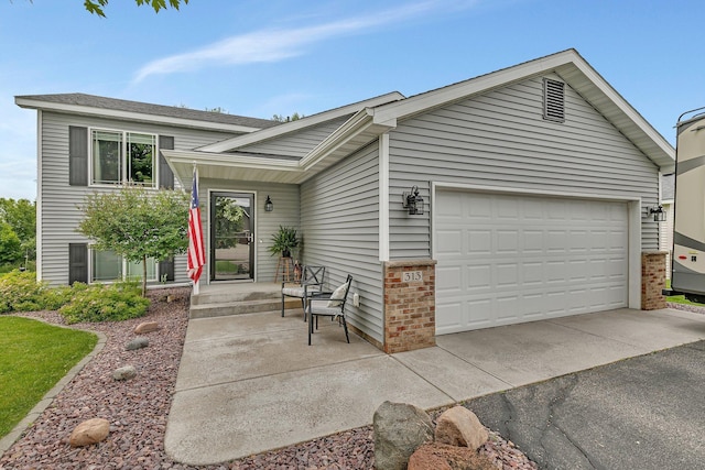 313 Victory Ave, Sartell, MN 56377 - tri-level home featuring an attached garage