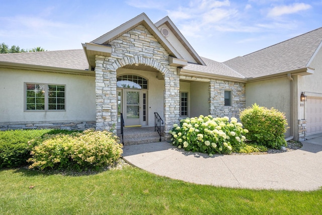 1215 Shore Dr SW, Hutchinson, MN 55350 - view of front of home with stone siding, stucco siding, and a shingled roof