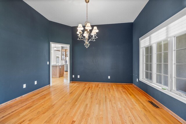 1215 Shore Dr SW, Hutchinson, MN 55350 - spare room with a chandelier and wood finished floors