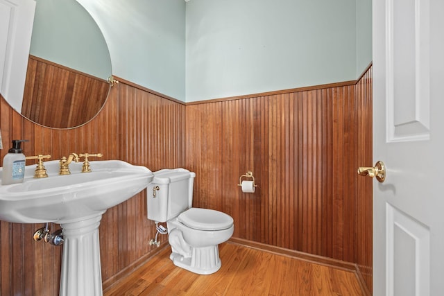1215 Shore Dr SW, Hutchinson, MN 55350 - half bath with wainscoting, wood finished floors, and wood walls