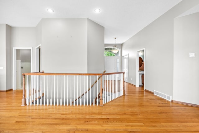 1215 Shore Dr SW, Hutchinson, MN 55350 - hallway with an upstairs landing, wood finished floors, and recessed lighting