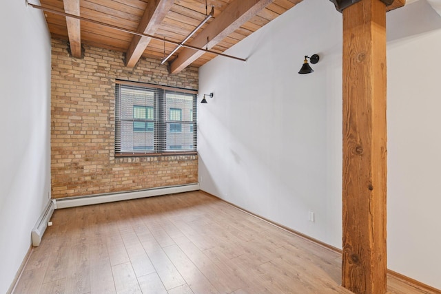 400 1st St Unit 502, Minneapolis, MN 55401 - empty room with a wood ceiling with exposed beams, brick wall, wood finished floors, and a baseboard radiator