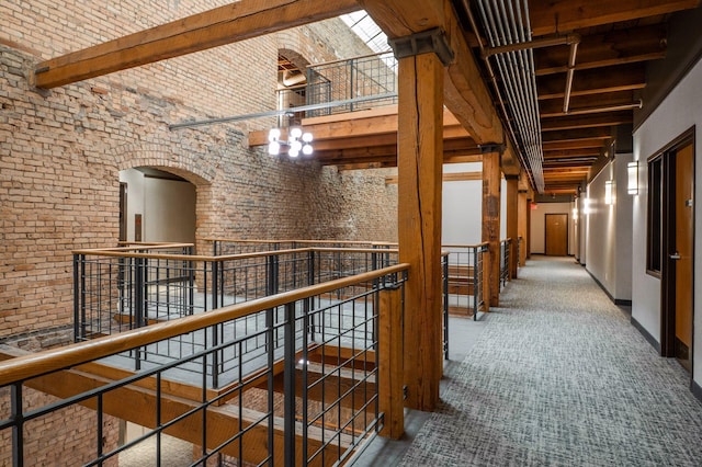 400 1st St Unit 502, Minneapolis, MN 55401 - corridor featuring a towering ceiling, an upstairs landing, arched walkways, beam ceiling, and brick wall