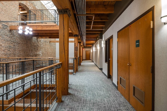 400 1st St Unit 502, Minneapolis, MN 55401 - corridor with a high ceiling, beam ceiling, carpet floors, and brick wall