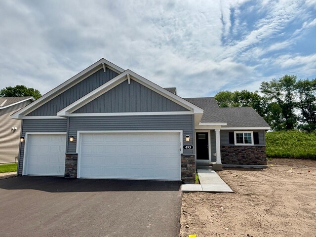493 Mallard St NE, Hanover, MN 55341 - craftsman-style house with stone siding, driveway, and a garage