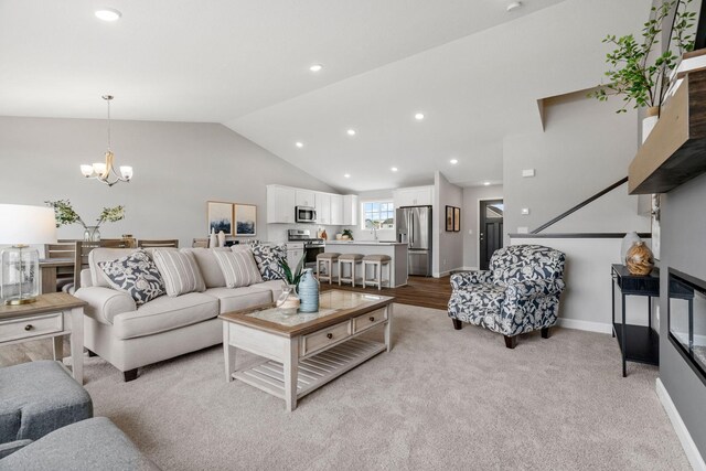 493 Mallard St NE, Hanover, MN 55341 - living area featuring vaulted ceiling, a chandelier, recessed lighting, and light colored carpet