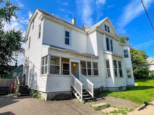 468 Minnehaha Ave E, Saint Paul, MN 55130 - view of front facade featuring a chimney and a sunroom