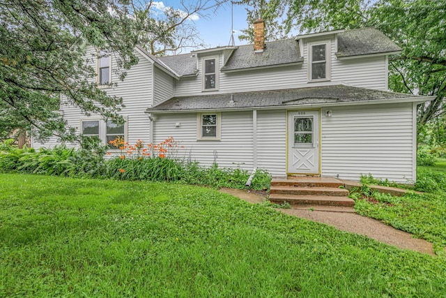 906 Holcombe Ave, Litchfield, MN 55355 - rear view of house with a yard, a chimney, and roof with shingles