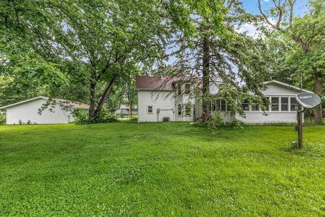 906 Holcombe Ave, Litchfield, MN 55355 - view of green lawn featuring a sunroom