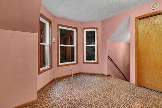 906 Holcombe Ave, Litchfield, MN 55355 - empty room featuring baseboards and a textured ceiling