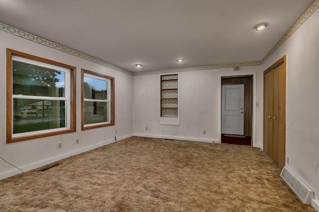 906 Holcombe Ave, Litchfield, MN 55355 - carpeted spare room with baseboards and recessed lighting