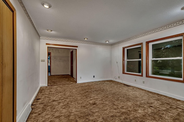 906 Holcombe Ave, Litchfield, MN 55355 - unfurnished room with carpet flooring, a textured ceiling, and crown molding