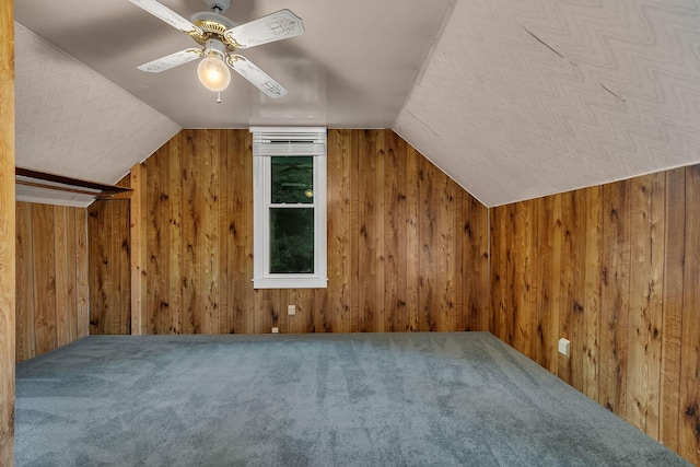 906 Holcombe Ave, Litchfield, MN 55355 - bonus room featuring ceiling fan, wooden walls, vaulted ceiling, and carpet