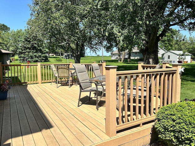 515 2nd St SW, New Richland, MN 56072 - wooden terrace with outdoor dining space and a yard