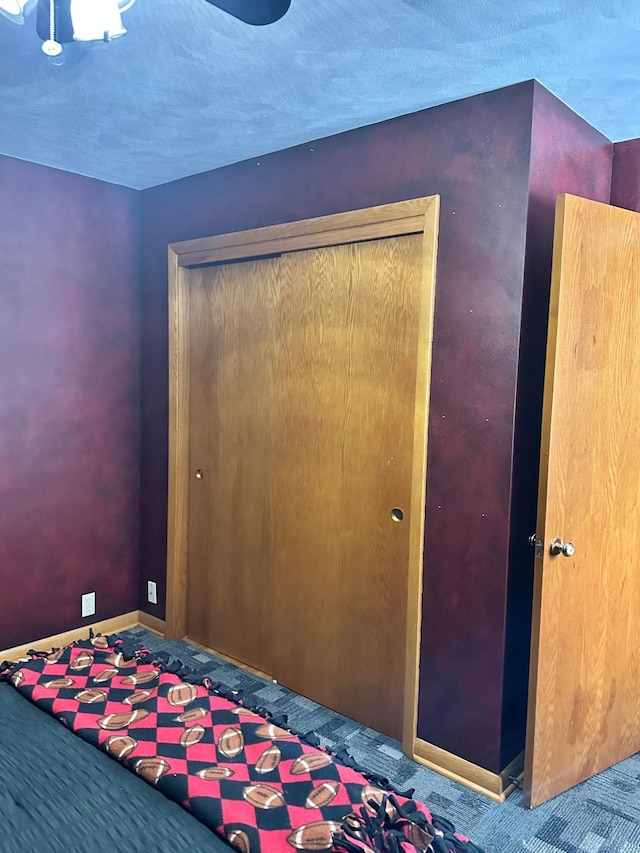 515 2nd St SW, New Richland, MN 56072 - unfurnished bedroom with carpet flooring, a closet, and ceiling fan