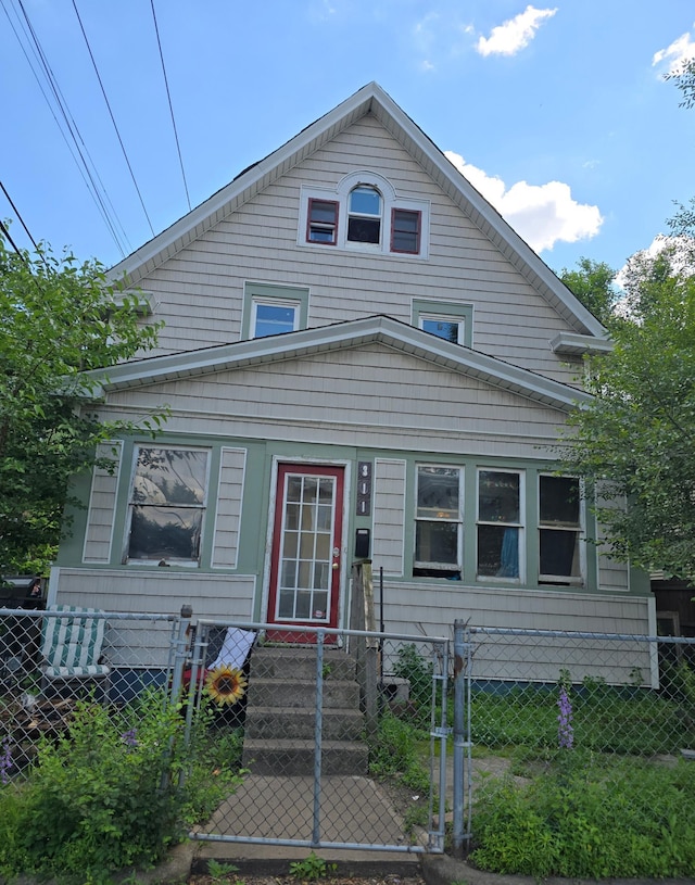 311 31st St E, Minneapolis, MN 55408 - view of front facade with a fenced front yard and a gate