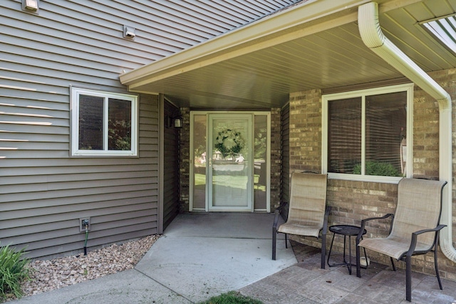 7140 Ivy Ridge Ct, Lino Lakes, MN 55014 - property entrance with a patio area and brick siding