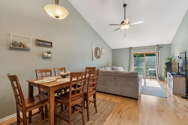 7140 Ivy Ridge Ct, Lino Lakes, MN 55014 - dining area featuring light wood finished floors, a ceiling fan, and high vaulted ceiling