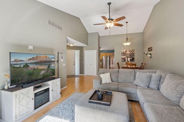 7140 Ivy Ridge Ct, Lino Lakes, MN 55014 - living area with high vaulted ceiling, ceiling fan, and light wood-style flooring