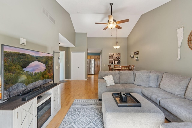 7140 Ivy Ridge Ct, Lino Lakes, MN 55014 - living area with high vaulted ceiling, light wood-type flooring, and a ceiling fan