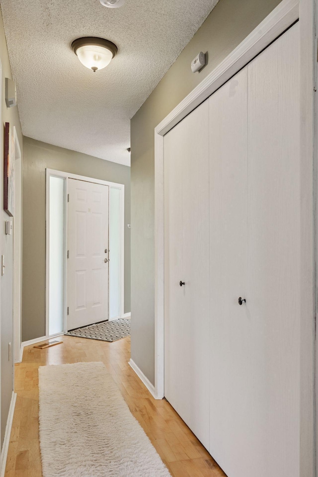 7140 Ivy Ridge Ct, Lino Lakes, MN 55014 - foyer featuring a textured ceiling and light wood-type flooring